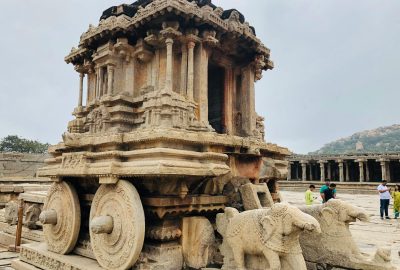 Iconic stone chariot at Vijaya Vitthala Temple, Hampi, exemplifying ancient Indian architecture.