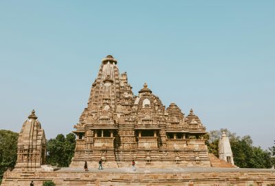 Stunning view of the historic Lakshmana Temple in Khajuraho, India under a clear blue sky.