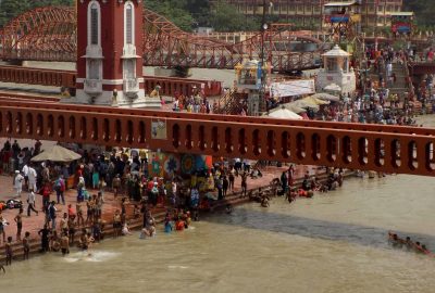 A vibrant scene of pilgrims bathing at the sacred Har Ki Pauri in Haridwar, India.
